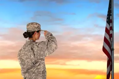 woman in uniform saluting the flag